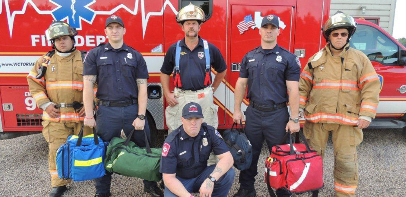 firefighters in front of ambulance